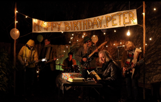 Watch R.E.M.’s Peter Buck Read A Book At His Birthday Party In New